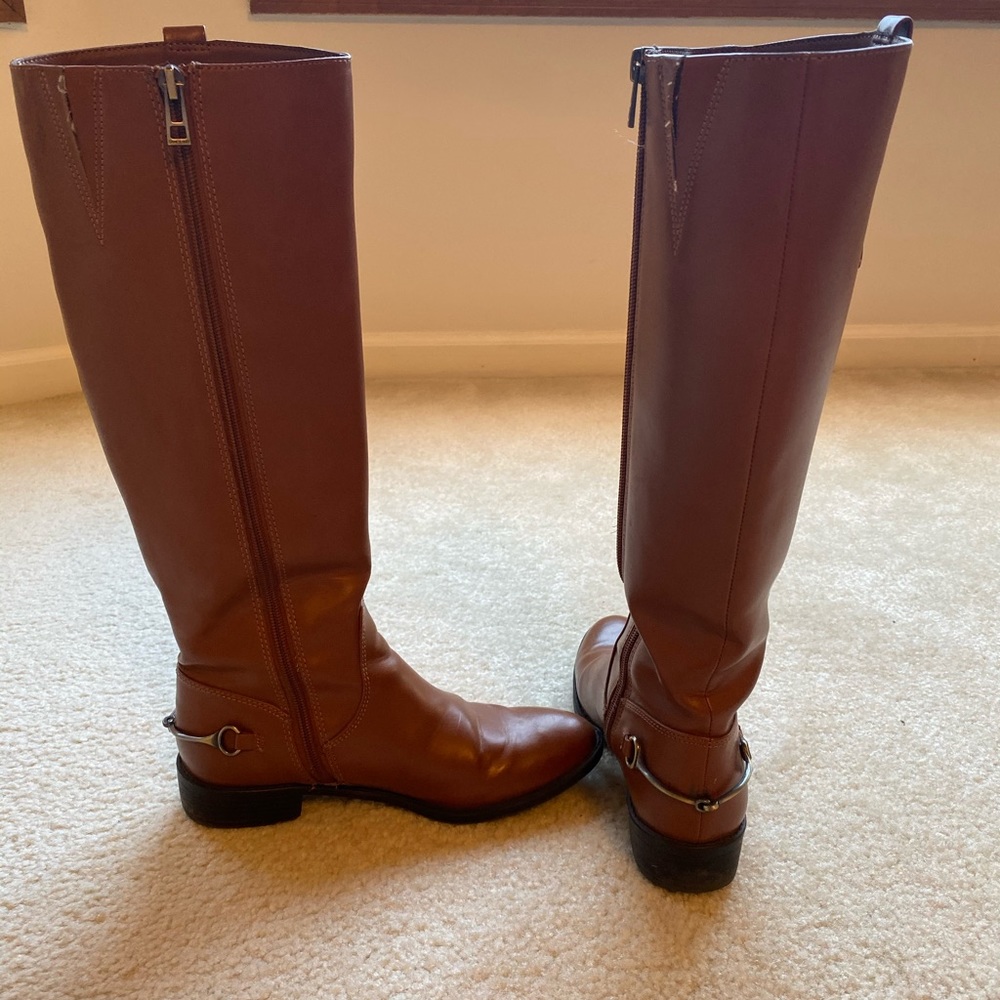 Brown zipper up boots with silver buckle on back